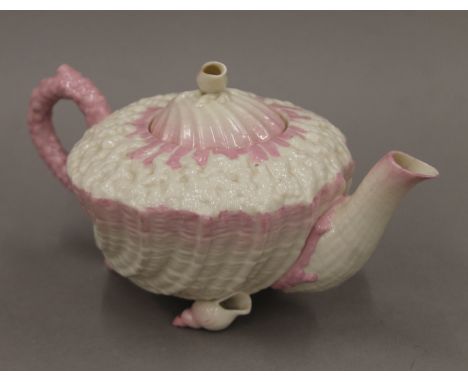 A Belleek porcelain teapot. 21 cm long.