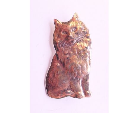 A silver brooch in the form of a cat. 3 cm high.