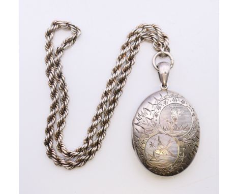 A silver locket with bird and owl motif on a rope twist chain.  Locket 5.5 cm high excluding suspension loop, chain 40 cm lon