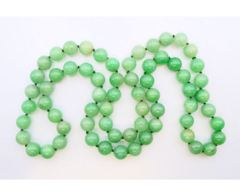 A string of jade beads.  84 cm long. 