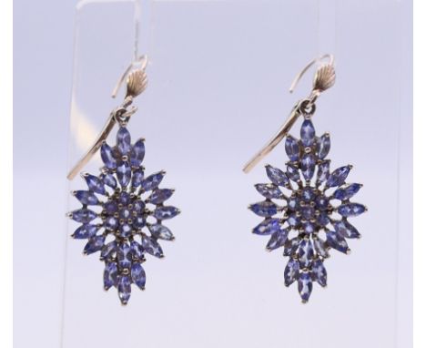 A pair of silver and tanzanite earrings.  2.5 cm high excluding suspension loop.