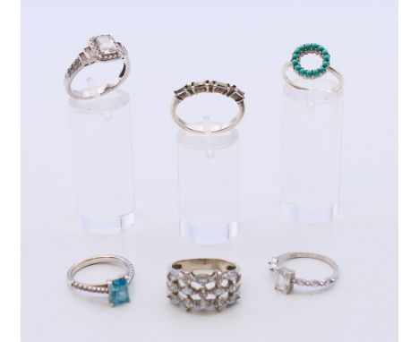 Six silver rings.