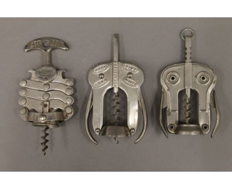Three bright plated corkscrews: magic lever, owl lever and zig zag concertina. The latter 15 cm high.
