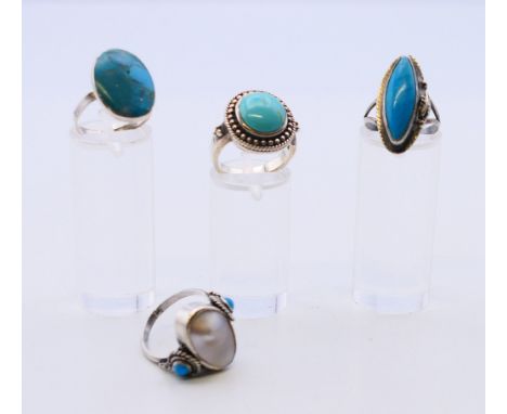 Four silver and turquoise rings.  Oval ring size O, round oval ring size O, torpedo shape ring size M, other ring size N/O.