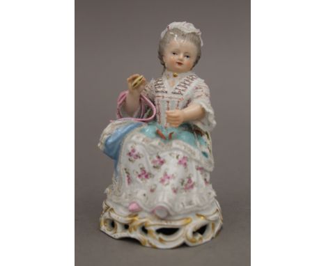 A Meissen porcelain model of a seated woman holding a clam shell. 12.5 cm high.