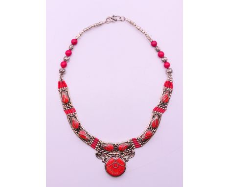 An unmarked silver and coral set necklace.  Approximately 42 cm long. 