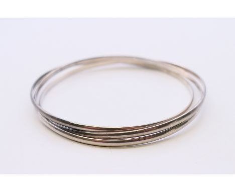 A silver triple-hoop bangle.  6 cm internal diameter. 