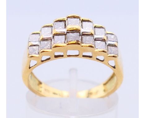 An 18 ct gold, one ct diamond step ring comprising fourteen diamonds arranged in pairs in step formation (marked 18K, maker's