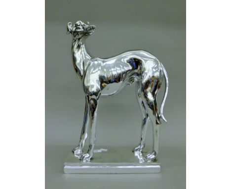 A silvered-coloured model of a greyhound. 46 cm high.