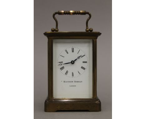 A brass cased carriage clock, the face inscribed Matthew Norman London. 11 cm high.
