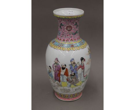 A Chinese famille rose porcelain vase, painted with immortals and scholars to one side and calligraphy to the other, seal mar