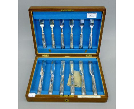 A cased silver fruit set of knives and forks. The case 30 cm wide.