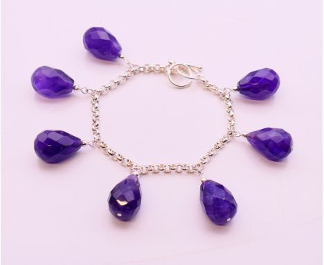 A silver and amethyst bracelet. 18 cm long.