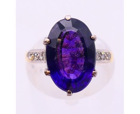 An 18 ct gold diamond and amethyst ring. Ring size J/K.