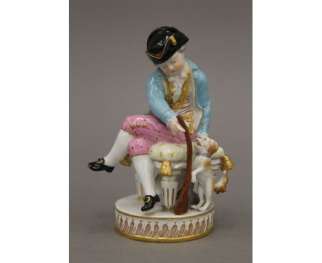 A Meissen porcelain model of a man with a gun and a dog. 14 cm high.