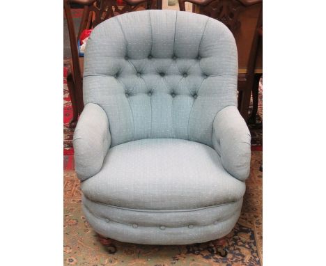 BLUE UPHOLSTERED BUTTON BACK LOW SEATED ARMCHAIR ON MAHOGANY SUPPORTS