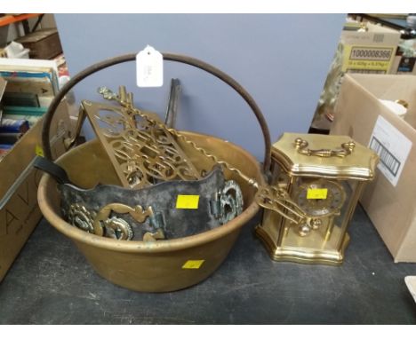 A brass jam pan, horse brasses, a trivet, and a cased perpetual motion mantle clock 