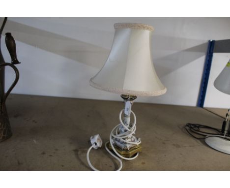 An oriental table lamp on metal base with cream shade  