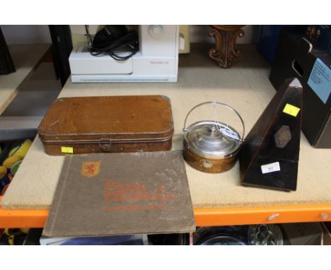 A cased metronome, an oak lidded tray, an album of photographs of the Scottish National Wart Memorial, and a vintage metal ti