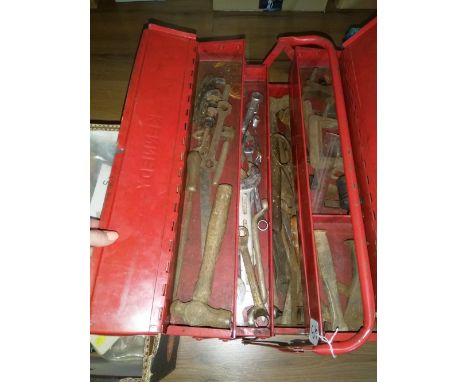 A red metal toolbox with contents, two boxes of plumbing fittings, cable clips, and other related items 