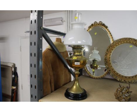 A Veritas Works brass oil lamp with white glass shade 