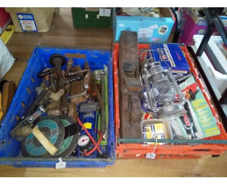 Two crates of vintage tools, a storm lantern, a wood working plane, and a halogen flood light 