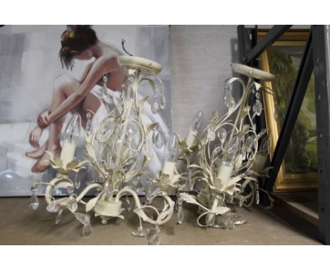A pair of decorative cream coloured metal light fittings   