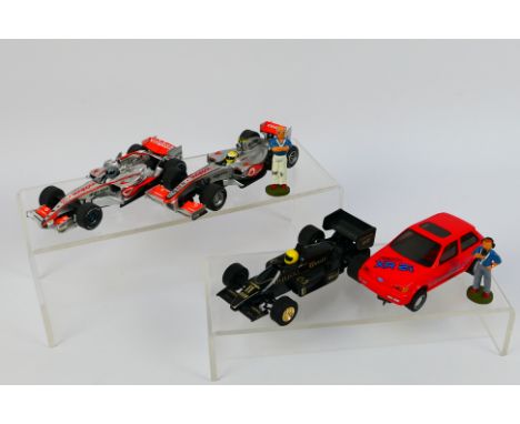 Scalextric - A group of unboxed Scalextric slot car with two unboxed white metal figures. Lot includes Scalextric Ford Fiesta
