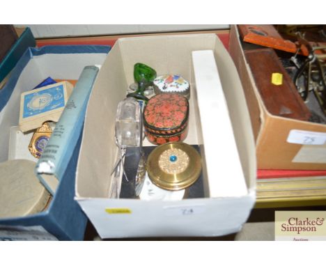A box containing various trinket boxes, scent bottle, portrait etc.