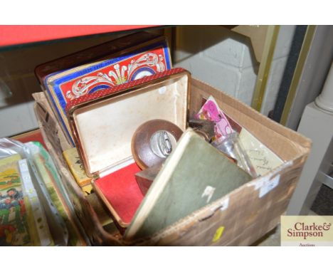 A box containing tins a flint lock table lighter, boxes etc.&nbsp;