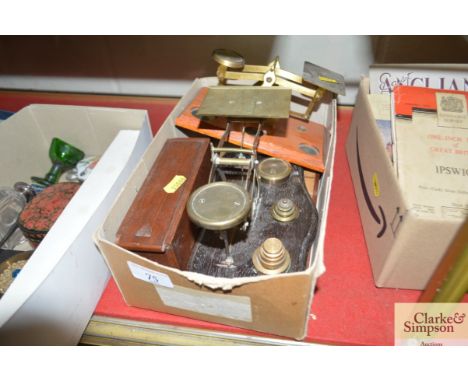 A box containing two sets of postage scales, cribbage board etc. 
