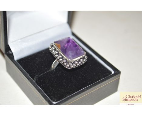 A boxed white metal and amethyst ring
