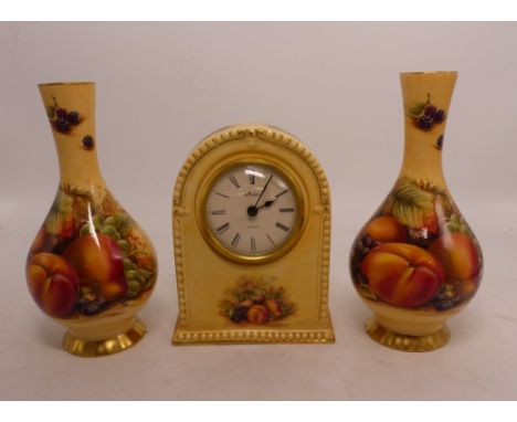 A three piece Aynsley mantle garniture suite consisting of a mantle clock and two bud vases (3).