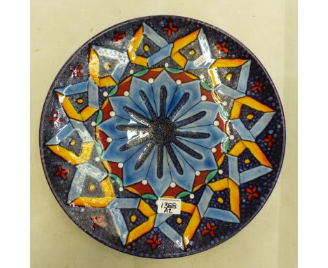 Large Poole charger in circular form, geometric design around a central medallion, diameter 40cm.