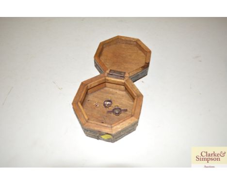 A hardwood and metal bound trinket box and contents of two British Legion brooches and a stick pin 