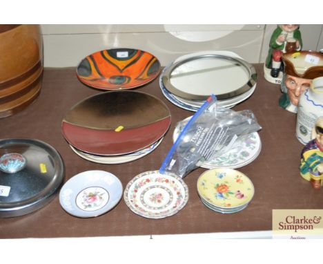 A Poole pottery peacock dish, various other decorative china plates, saucers, a mirrored stand and a collection of cutlery 