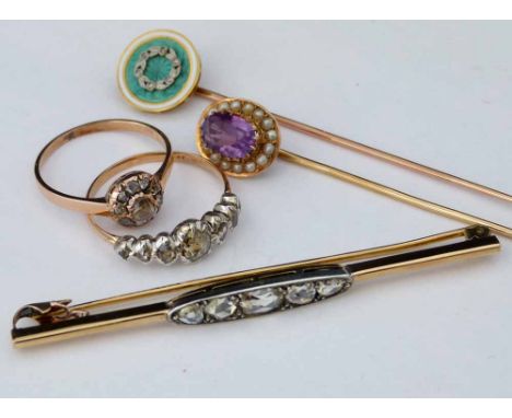 Unmarked gold antique bar brooch set with five rose cut diamonds; an antique gold rose-cut diamond ring in a floret setting; 