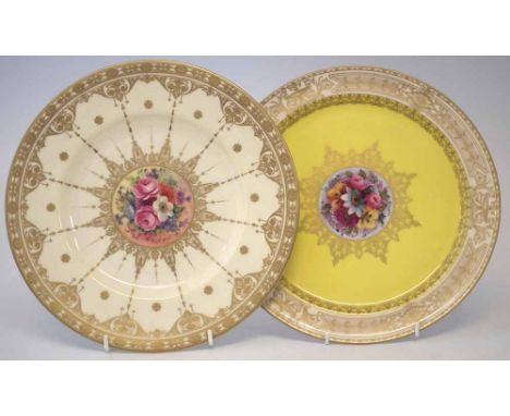 Two Royal Worcester plates, one signed Phillips, painted with floral studies within elaborate gilt borders, date codes for 19