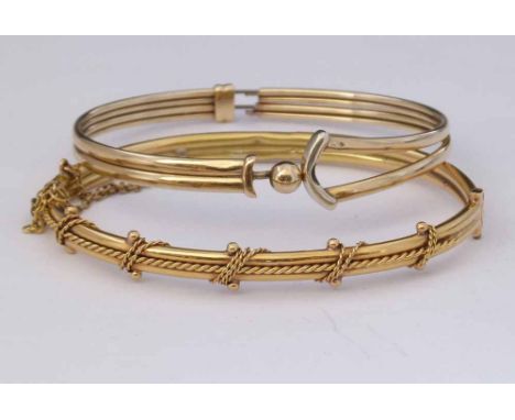 18ct gold hinged bangle, 10.9g, and a 9ct bangle with sprung metal core (2).