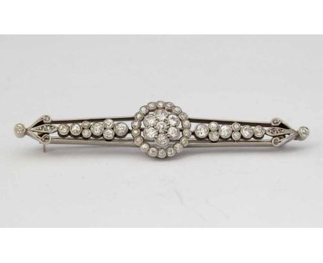 18ct white gold and platinum diamond bar brooch, circa 1920, the central millegrain floret flanked by tapering bands of old E