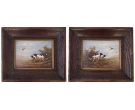 Pair of Crown Devon plaques signed R. Hinton painted with two gun dogs watching flying partridge, with oak frames, the plaque