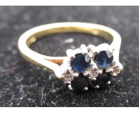 Hallmarked 18ct yellow gold diamond and sapphire ring, four claw set round cut sapphires  and three diamonds, stamped 750, si