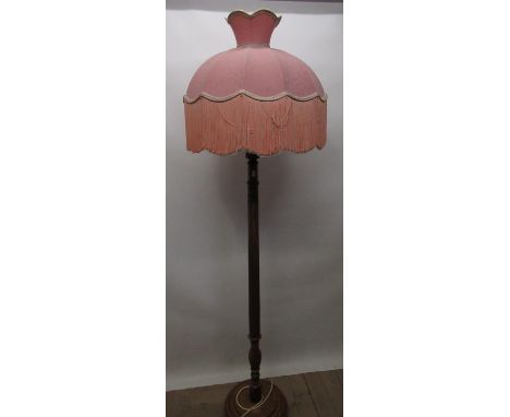 Geo. III style walnut standard lamp with fluted column, with pink fringed shade on stepped circular base 