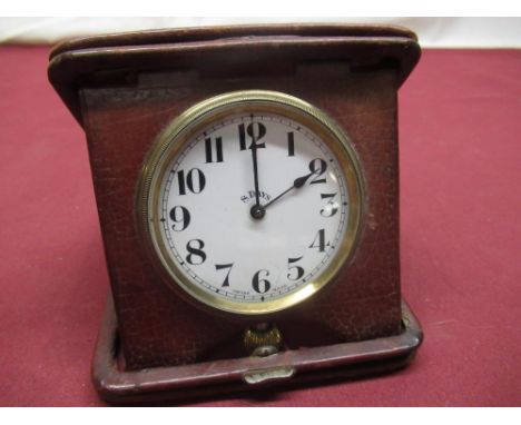 Doxa early C20th red leather cased travel clock, folding case, white enamel dial with Arabic numerals, screw off brass bezel,