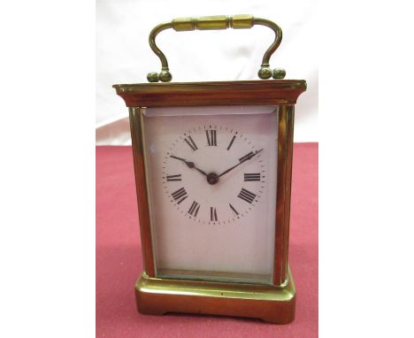 Early C20th French brass cased carriage clock time piece with white enamel dial, bevel edged glass panels, visible later leve