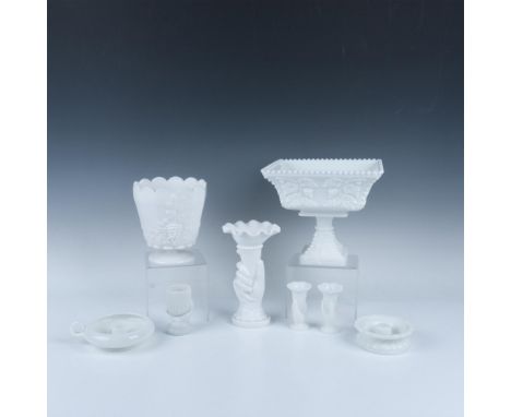 A set of eight milk glass items features two Fenton lamp shade bases, a toothpick holder sculpted as a hand grasping a contai