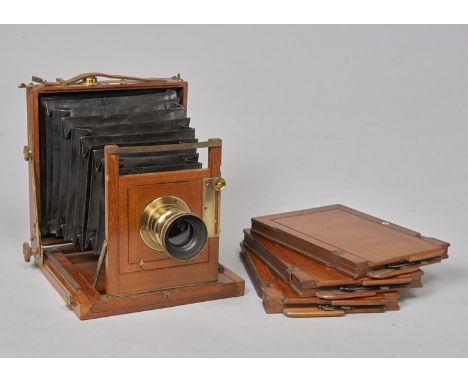 An early 20th Century Army & Navy mahogany and brass Half-Plate Field Camera,  with retailer's plate A & N Auxiliary C S Ld, 