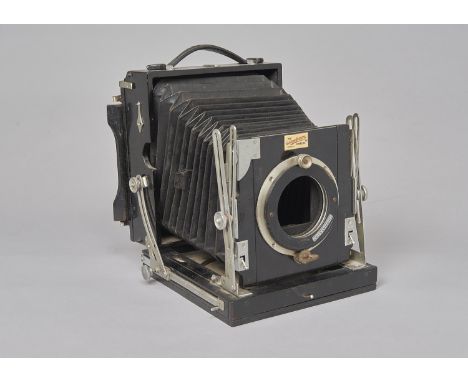 A Houghton Triple Victo mahogany and brass Half-Plate Field Camera,  lens board adapted with Thomas Day bulb shutter, with va