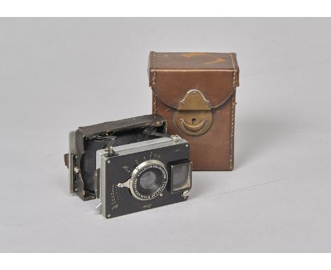 A Zelauf Bebe Folding Strut Camera, serial no 1093, black, body F-G, some minor leather degredation, shutter working, focussi