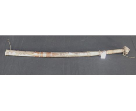 A 19TH CENTURY INDONESIAN SWORD with white metal lobed pommel, filigree decoration to the wood scabbard, and curved blade, 91